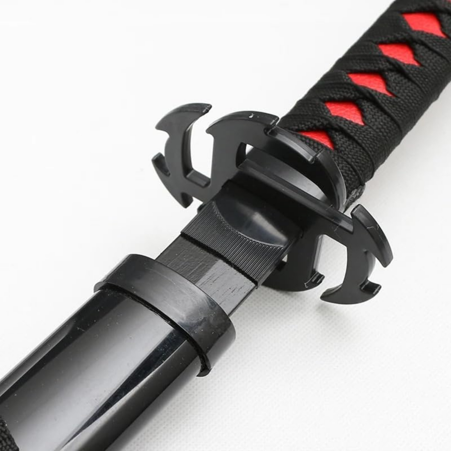 Black and red Ichigo Kurosaki wooden katana from Bleach anime, with jagged blade and decorative guard