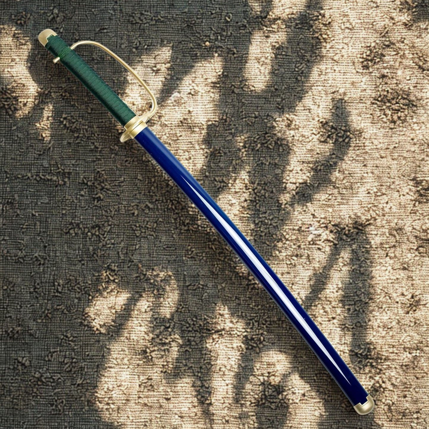 Shanks wooden katana unassembled anime replica with gold hilt, black blade, and blue scabbard displayed on floral sand background