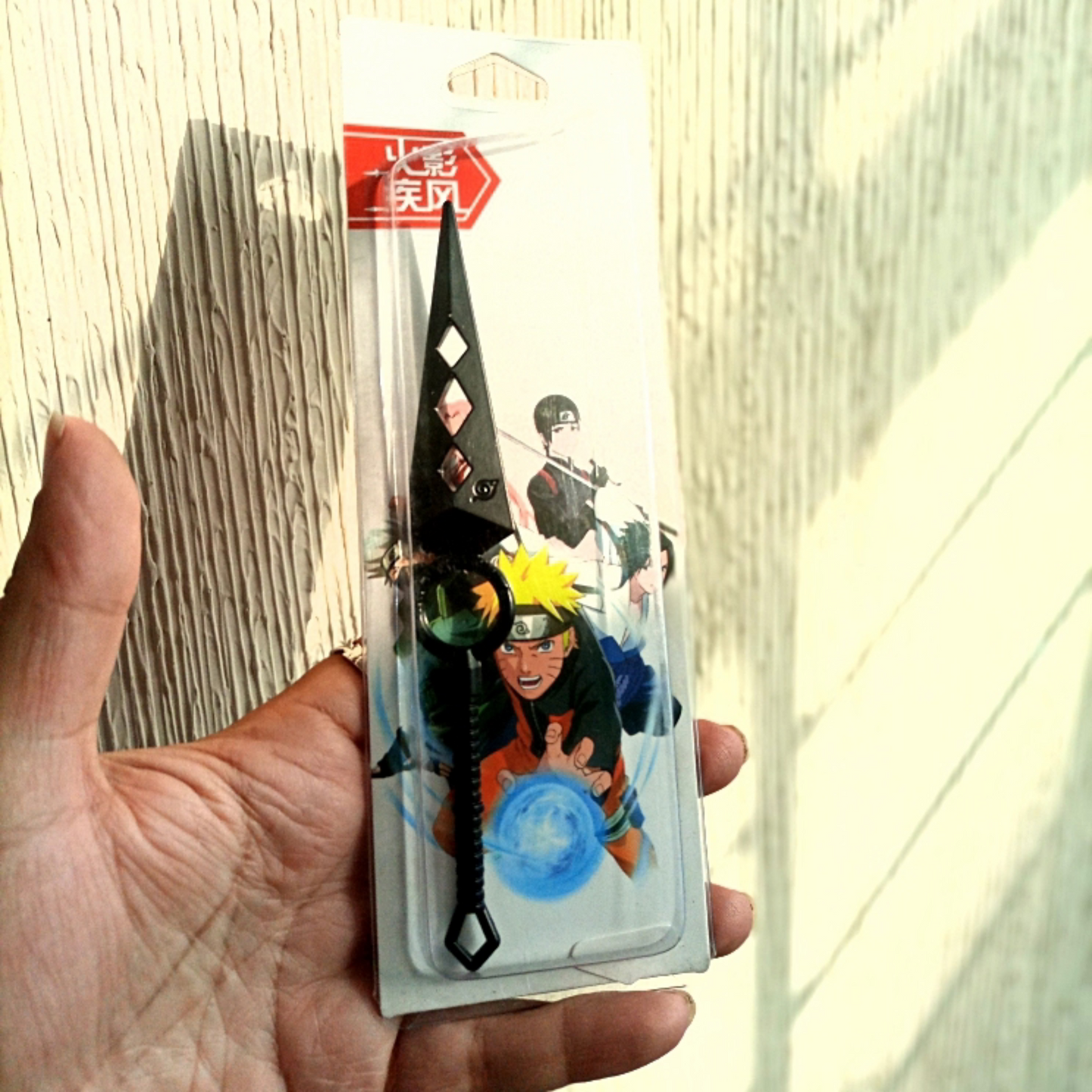 Naruto Uchiha clan kunai with diamond cutouts and red engraved symbols on black blade