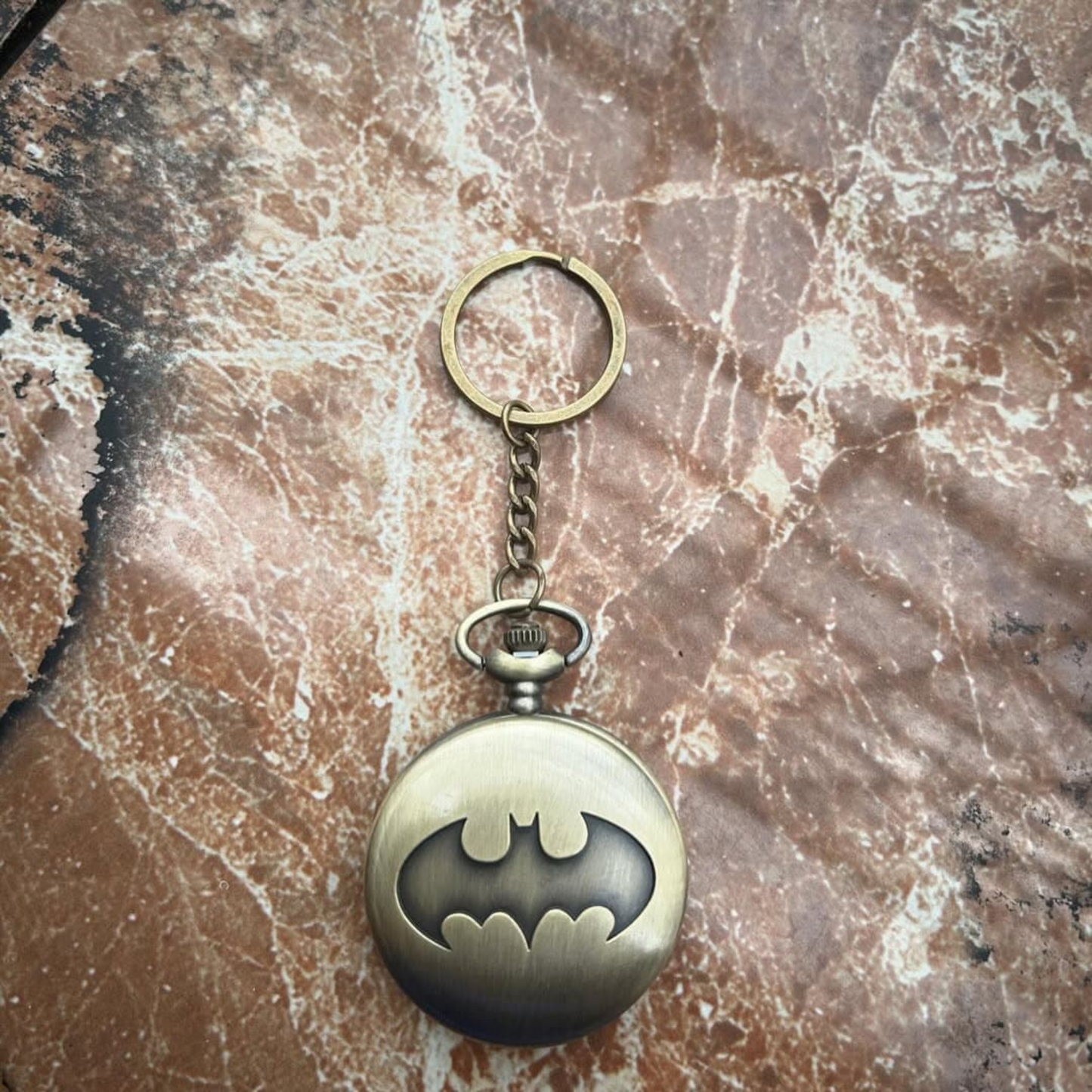 Vintage-style Batman metal pocket watch with keychain attachment featuring the iconic bat symbol