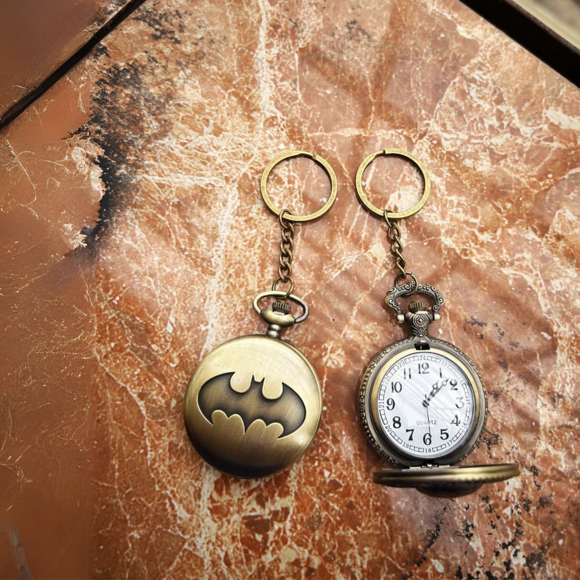 Vintage-style Batman metal pocket watch with keychain attachment featuring the iconic bat symbol