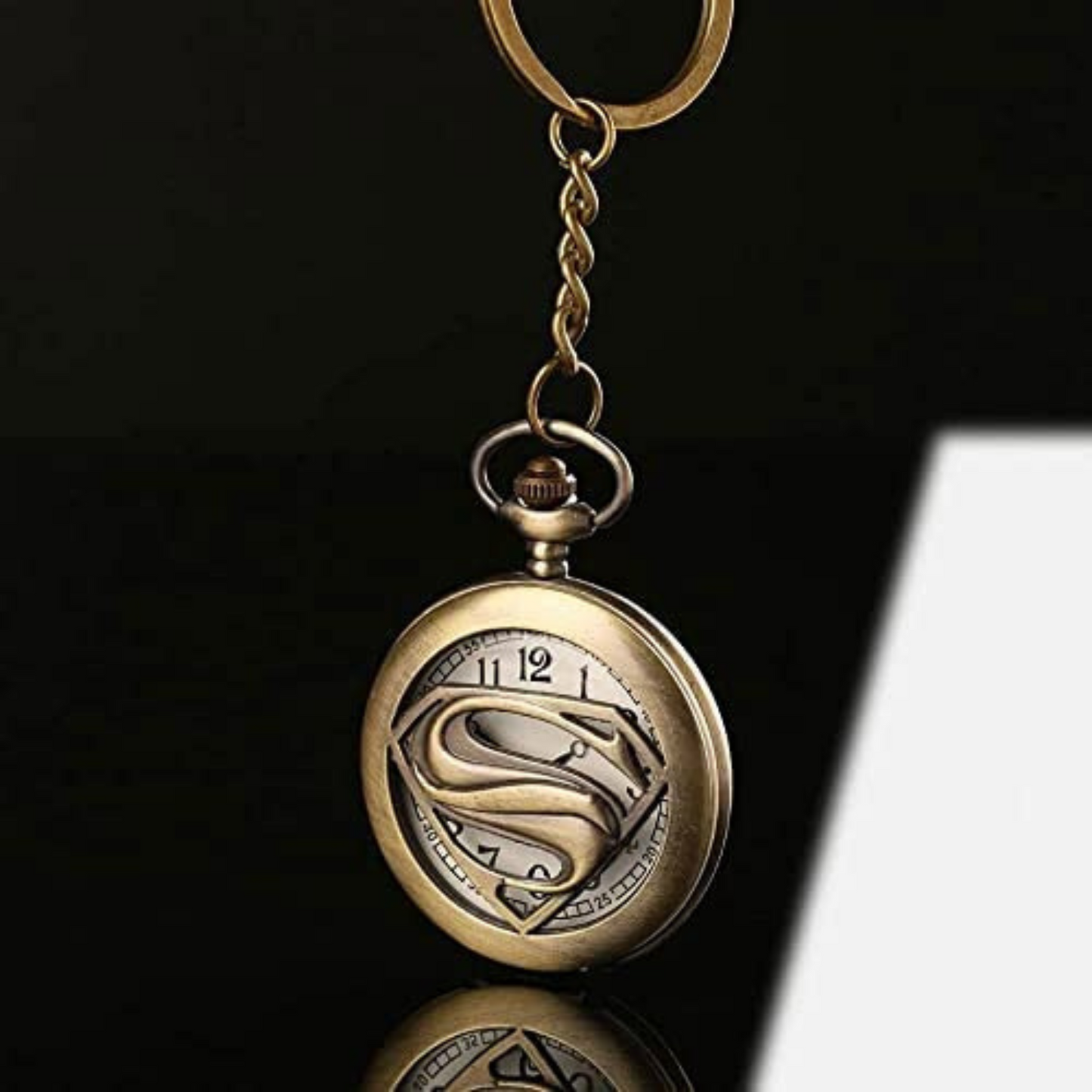Vintage bronze Superman metal pocket watch keychain with open-view dial and iconic 'S' emblem