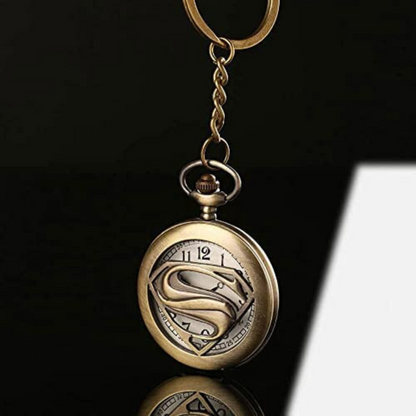 Vintage bronze Superman metal pocket watch keychain with open-view dial and iconic 'S' emblem