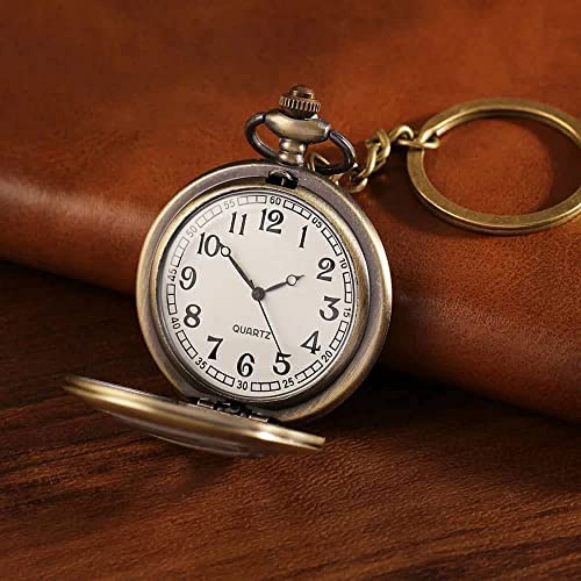 Vintage bronze Superman metal pocket watch keychain with open-view dial and iconic 'S' emblem