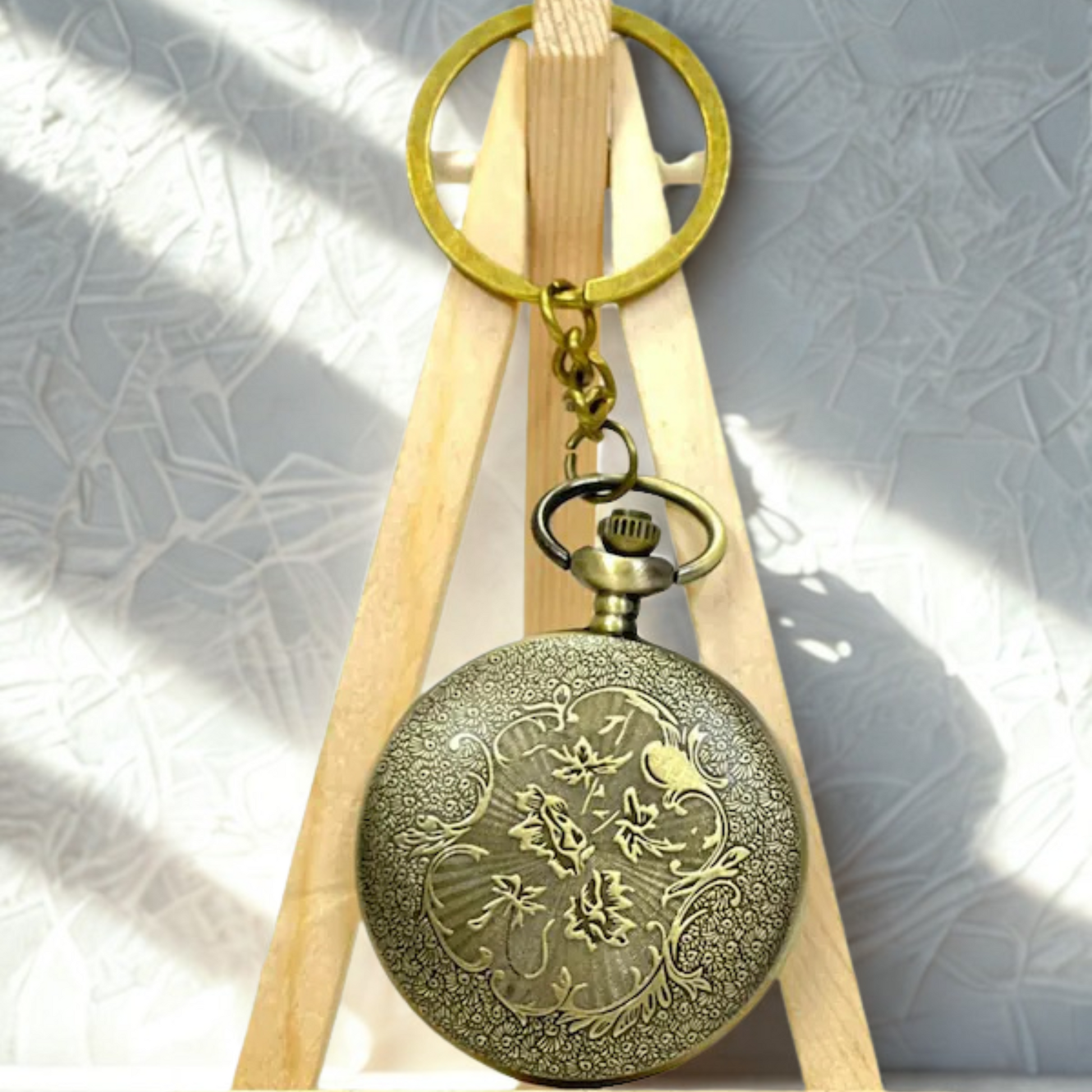 Vintage bronze Superman metal pocket watch keychain with open-view dial and iconic 'S' emblem