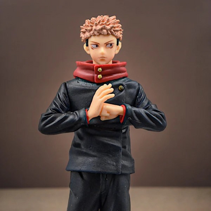 Jujutsu Kaisen Itadori Yuji action figure in school uniform with red hoodie, standing on a display base against a red-dark background
