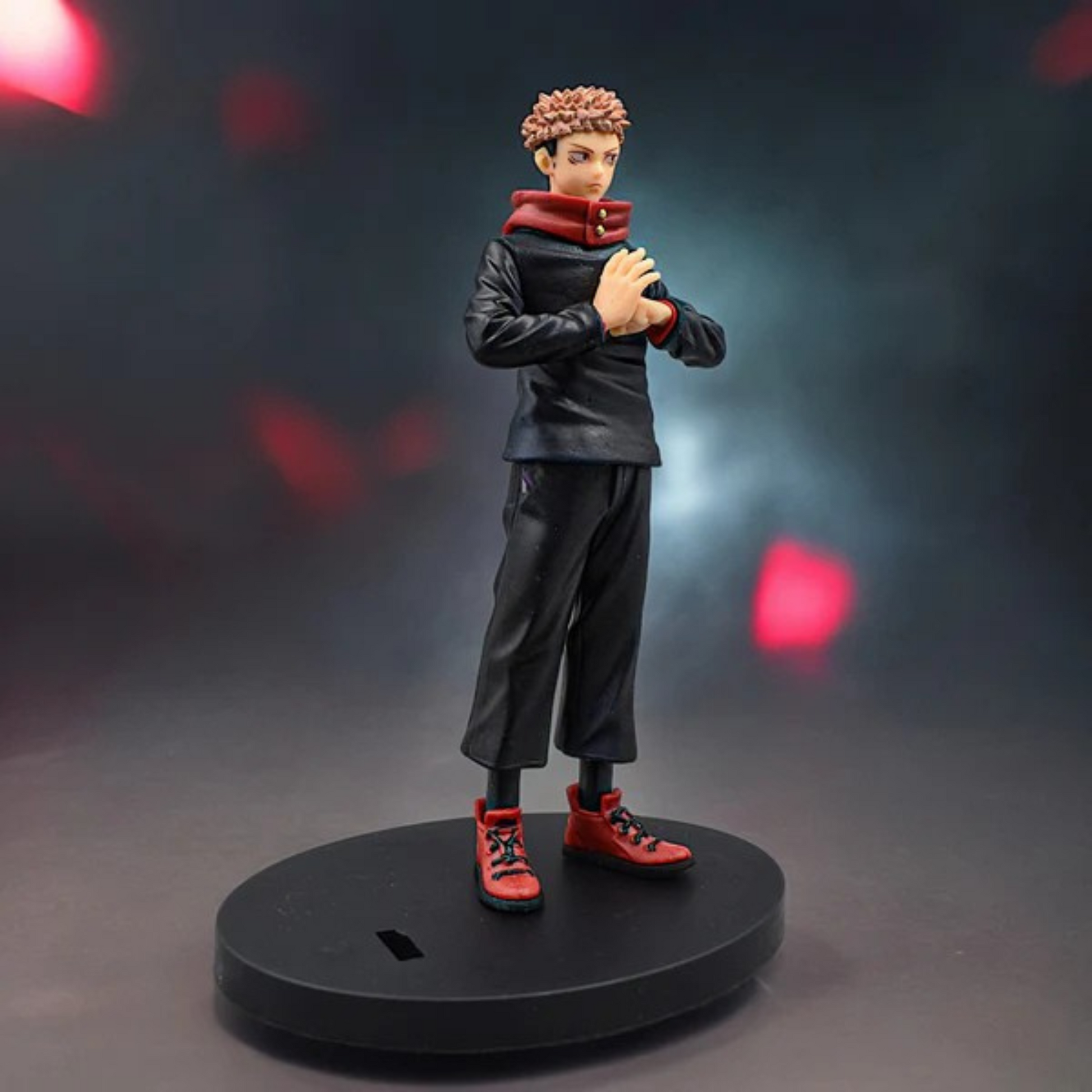 Jujutsu Kaisen Itadori Yuji action figure in school uniform with red hoodie, standing on a display base against a red-dark background