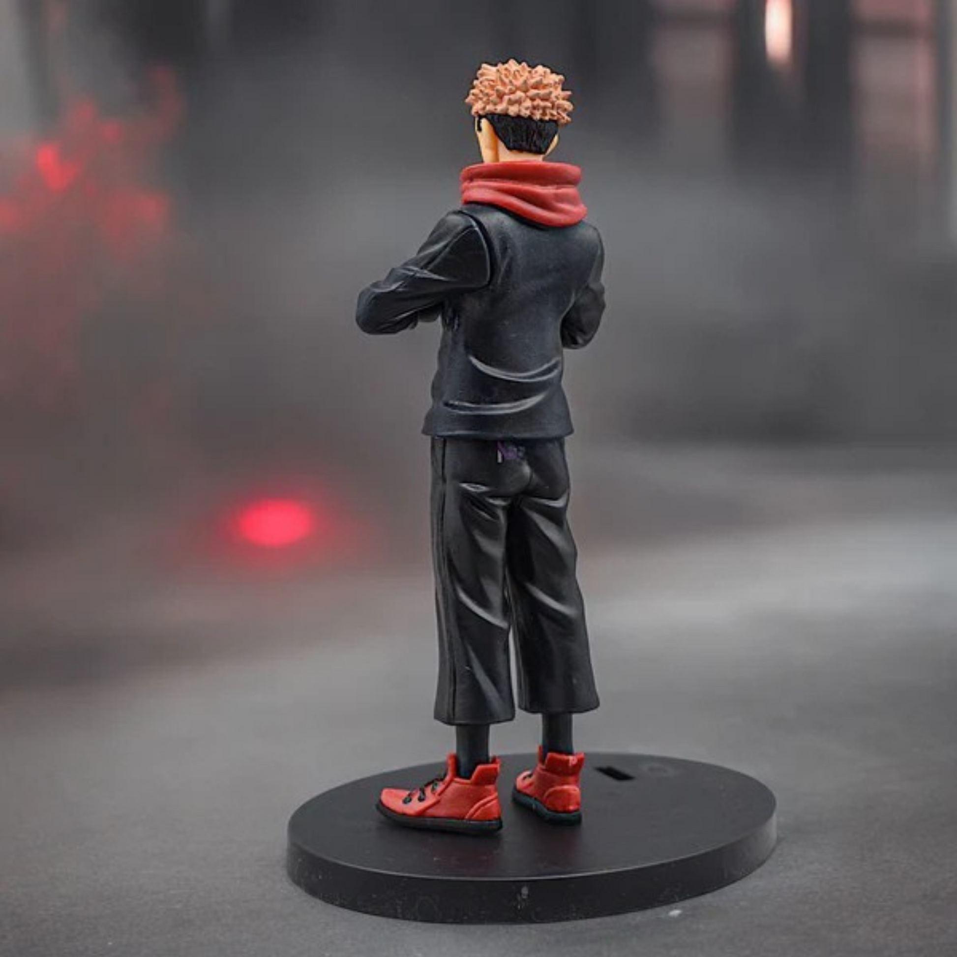 Jujutsu Kaisen Itadori Yuji action figure in school uniform with red hoodie, standing on a display base against a red-dark background