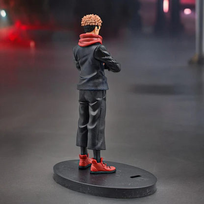 Jujutsu Kaisen Itadori Yuji action figure in school uniform with red hoodie, standing on a display base against a red-dark background
