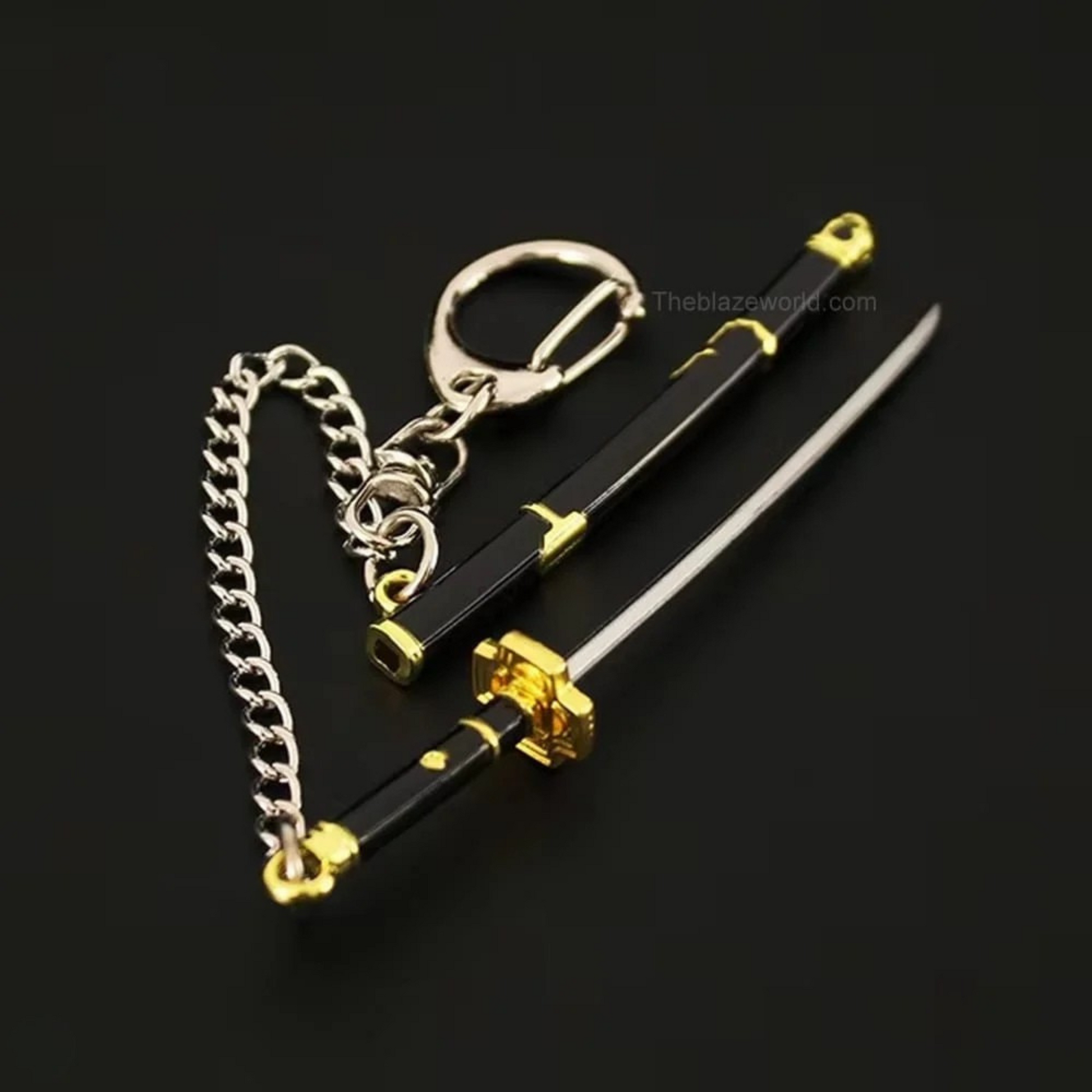 Black and gold Yubashiri katana keychain inspired by One Piece's Roronoa Zoro, placed on a dark fabric background