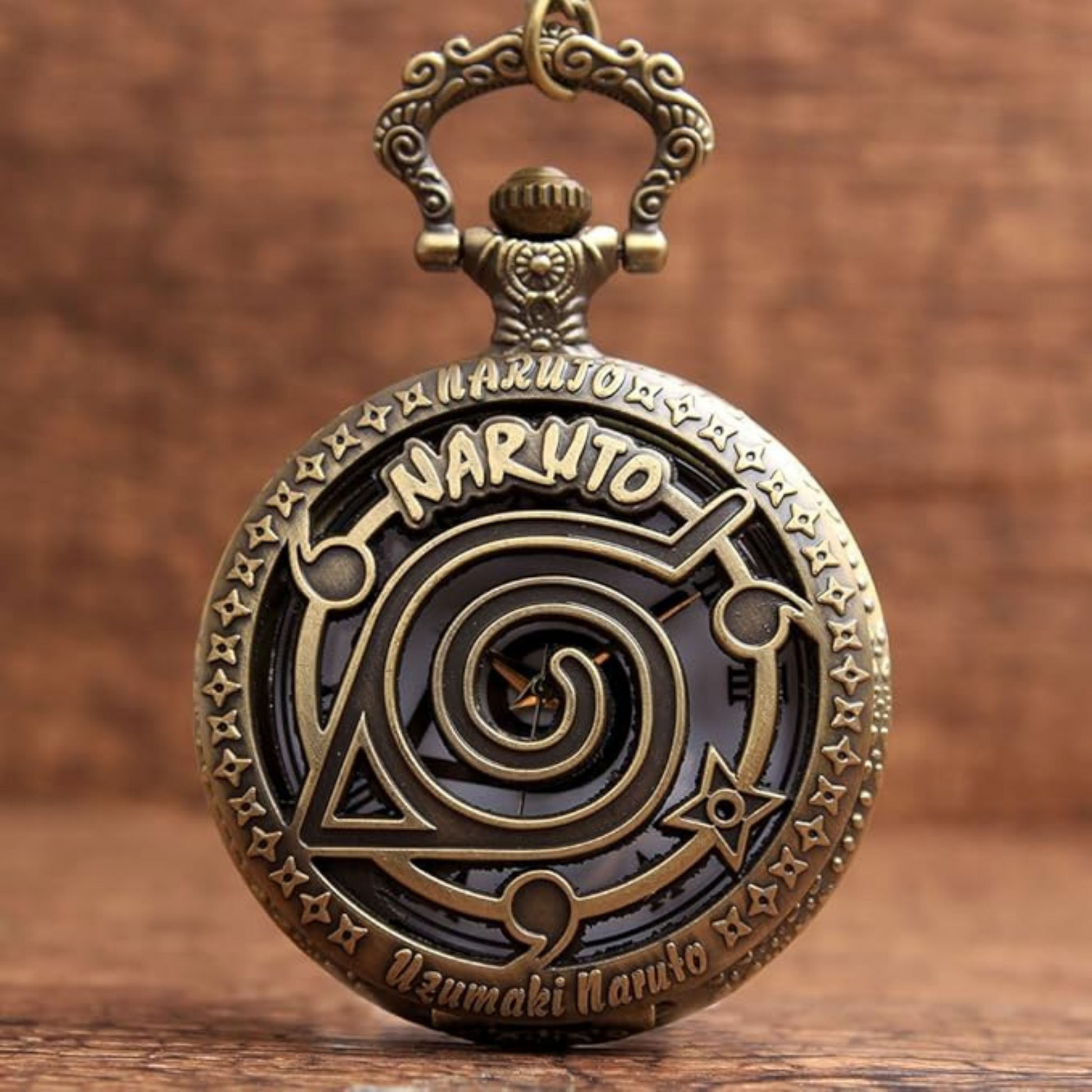 Vintage-style Naruto pocket watch keychain with engraved Hidden Leaf Village swirl symbol and Uzumaki Naruto text on the front cover, in antique bronze finish.