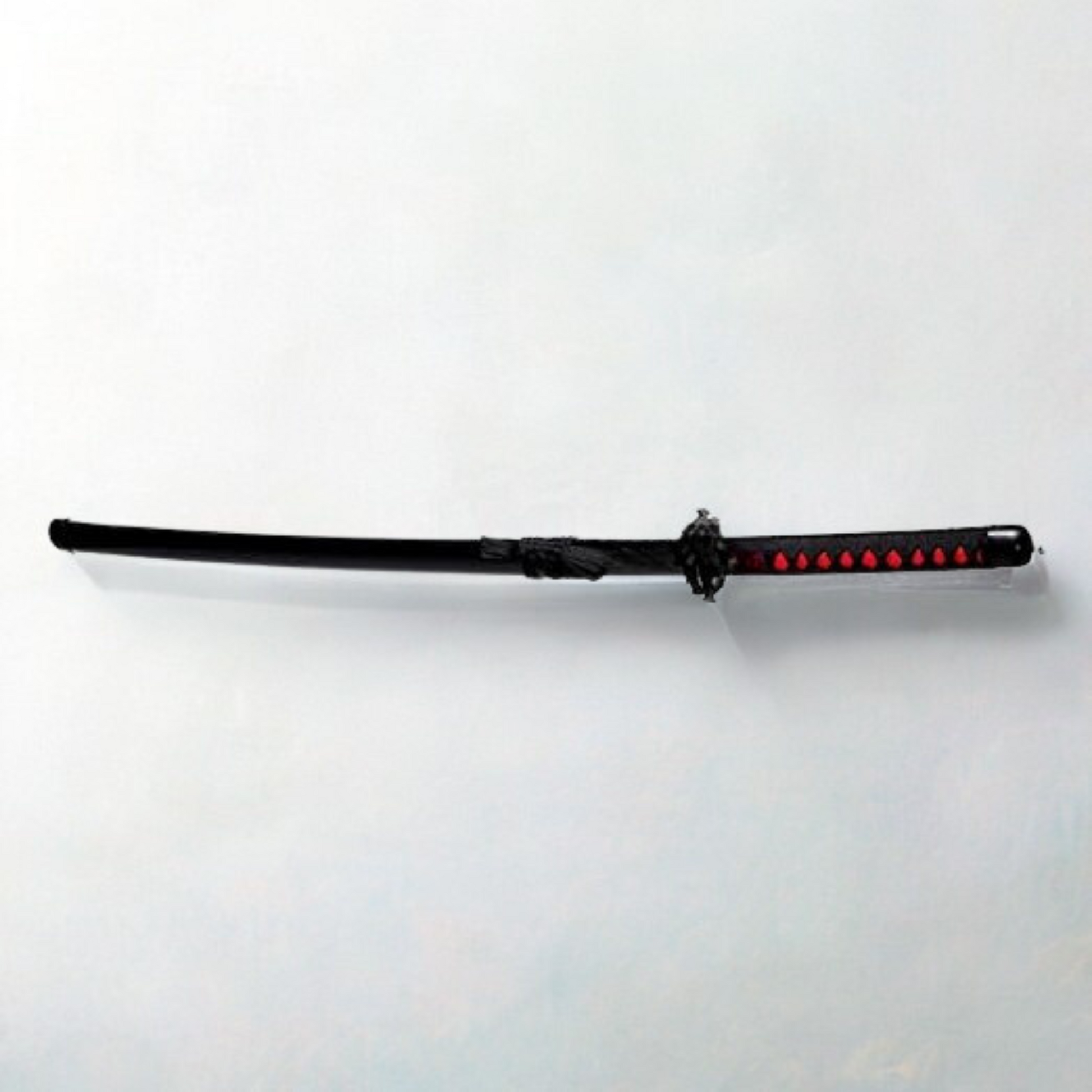 Black and red Ichigo Kurosaki wooden katana from Bleach anime, with jagged blade and decorative guard
