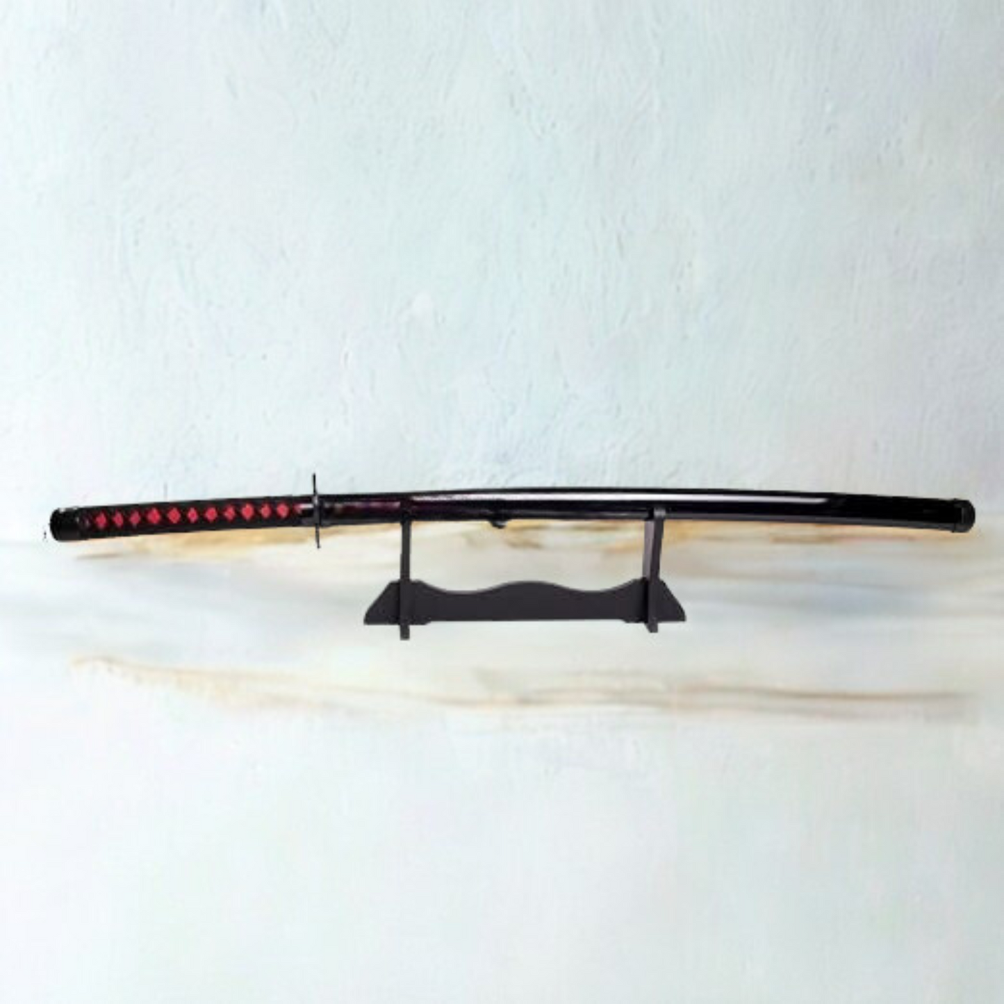 Black and red Ichigo Kurosaki wooden katana from Bleach anime, with jagged blade and decorative guard