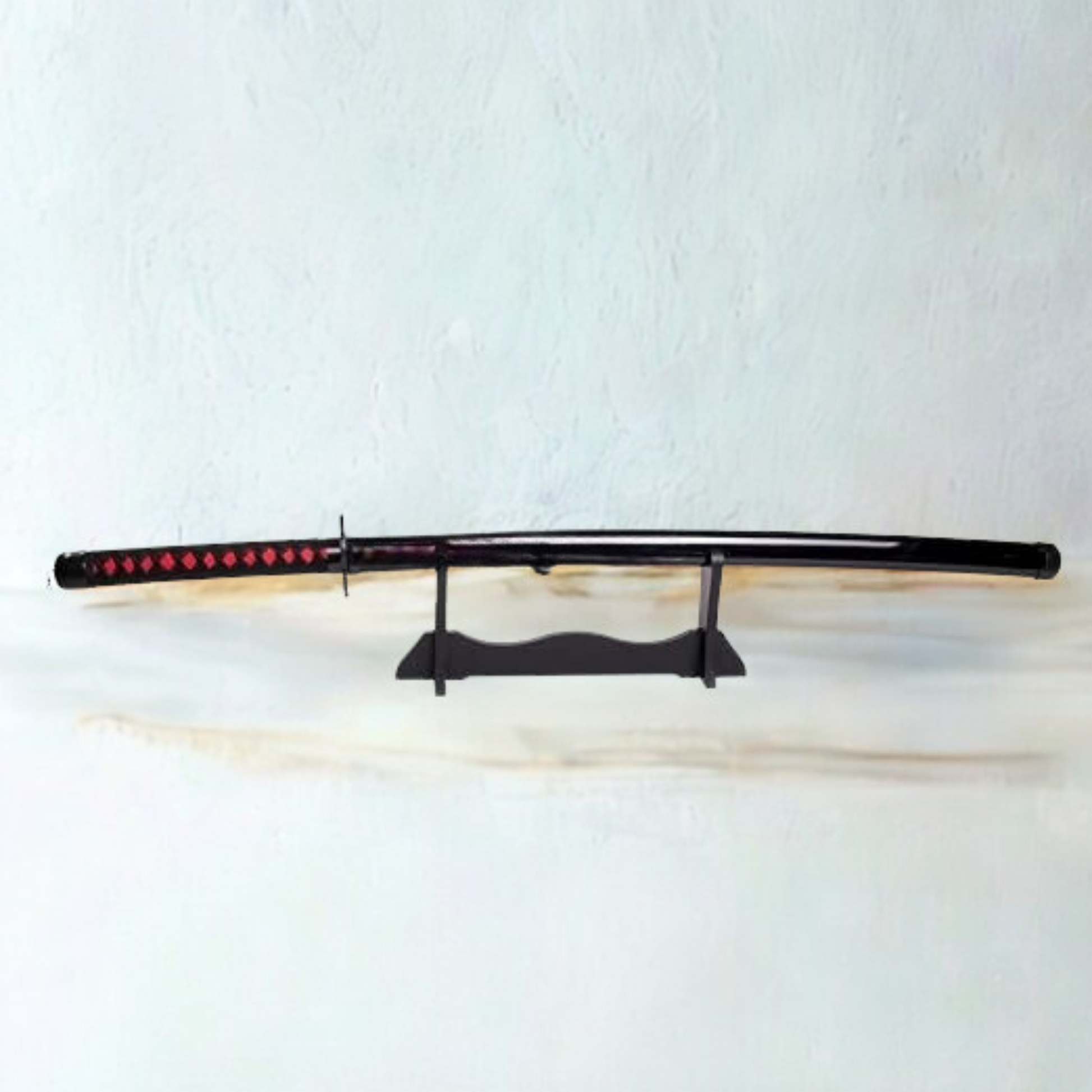 Black and red Ichigo Kurosaki wooden katana from Bleach anime, with jagged blade and decorative guard