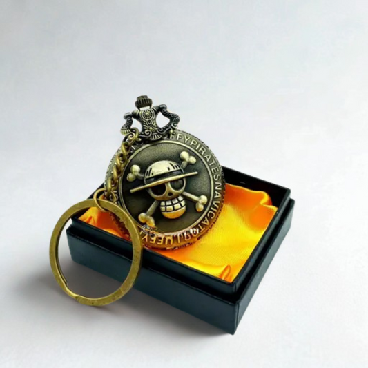 One Piece Luffy Pirate Crest Antique Pocket Watch Keyring with bronze finish, engraved Straw Hat Jolly Roger emblem, placed in a satin-lined black gift box.