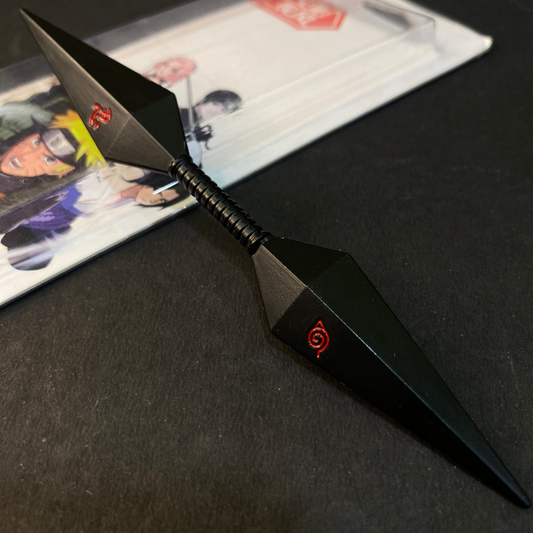 Naruto-inspired Kusuna Kunai Knife with dual black blades and red Leaf Village symbol, placed on a Naruto-themed background