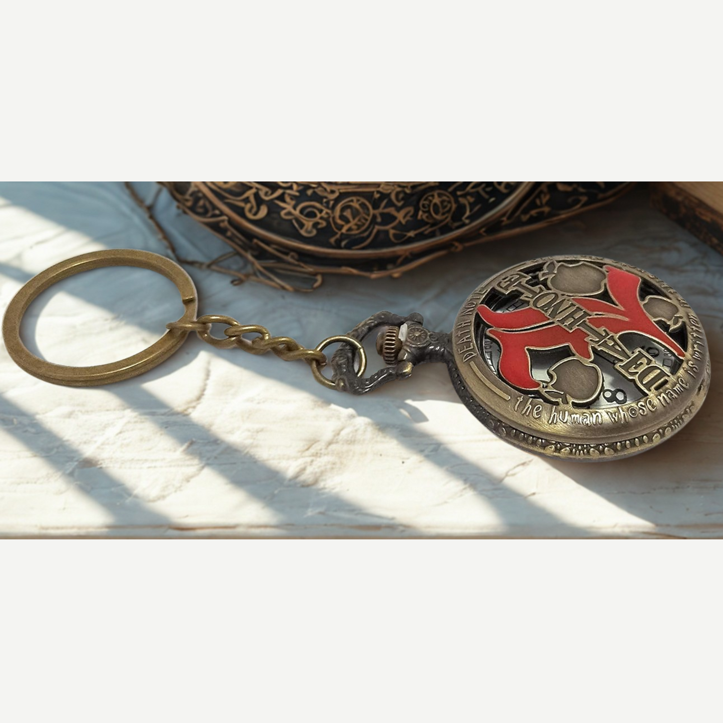 Close-up of engraved Death Note pocket watch with bold numerals and sleek finish